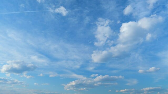 Fluffy layered clouds sky atmosphere. Puffy fluffy white clouds. Formation cloud sky scape. Time lapse.