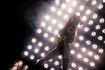 Sexy girl dance on front of spot light wall with smoke