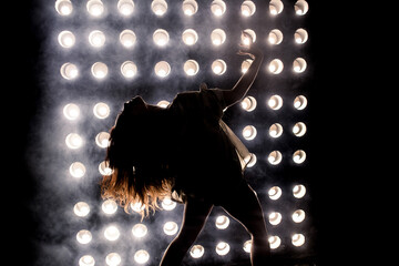 Sexy girl dance on front of spot light wall with smoke