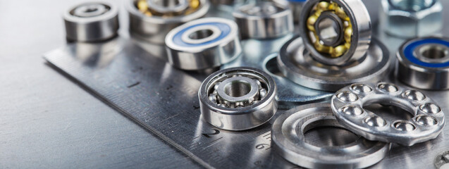 different bearings, vernier caliper and ruler on metal background. Part of mechanism.