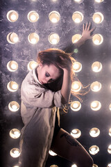 Sexy girl dance on front of spot light wall with smoke