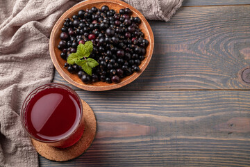 blackcurrant compote in a glass and berries on a table top view