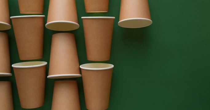 Pattern of craft paper cups on a green background. Looped 4K stop motion animation