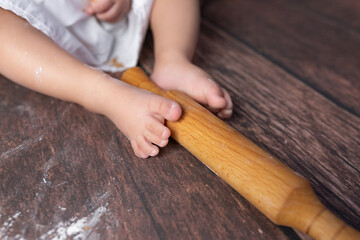 Obraz na płótnie Canvas small children's feet in flour on a wooden background