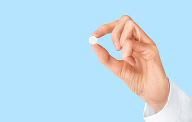 Pill of painkiller in doctor hand. Pharmacy, pharmacology, medicine concept