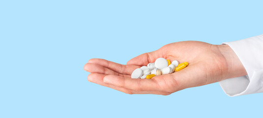 Pills in doctor hand. Pharmacy, pharmacology, medicine concept