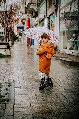 little girl with umbrella goes in the center from varna bulgaria 