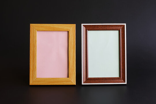 Two blank empty frames for pictures, photos or ads. Black background. Filled interior element. The concept of amnesia and memory loss. Copy space.
