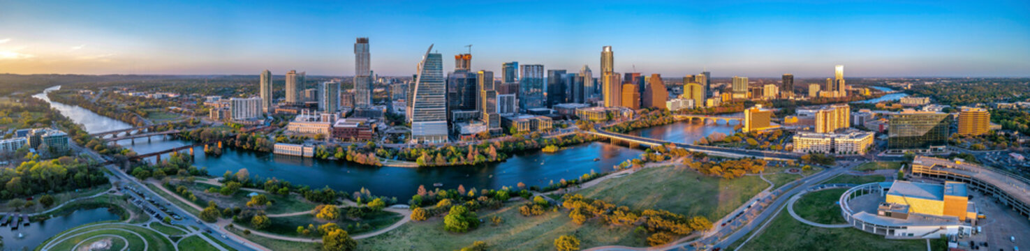 Panoramic cityscape of Austin, Texas near the Colorado River against the sunset skyline