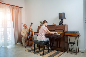 Father and daughter playing music together,Happy moment while playing piano at home.