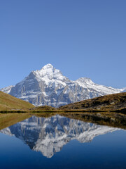 Rocky mountains and reflection on the surface of the lake. Landscape in Grindelwald, Switzerland.