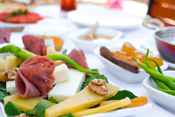 Delicious traditional Turkish breakfast on white table close up