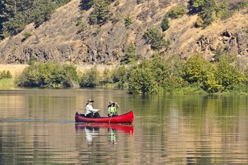 Fototapeta na wymiar Couple paddling a canoe in Idaho.