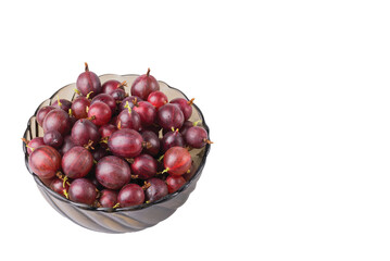 Close up view of bawl with ripe red gooseberries on white background isolated. 
