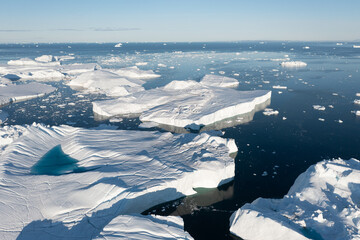 Climate change and global warming. Icebergs from a melting glacier in Ilulissat Glacier, Greenland. The icy landscape of the Arctic nature in the UNESCO world heritage site. Aerial view durin summer d