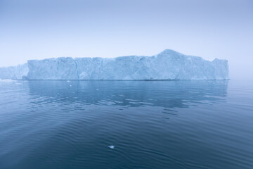 Obraz na płótnie Canvas Climate change and global warming. Icebergs from a melting glacier in Ilulissat Glacier, Greenland. The icy landscape of the Arctic nature in the UNESCO world heritage site.