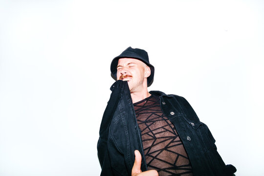 Portrait of androgynous model On Isolate Background Biting His Jacket - Powered by Adobe