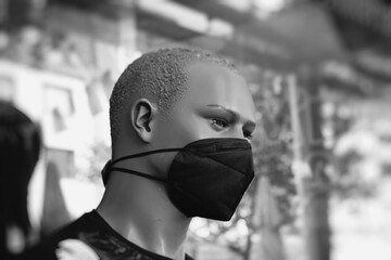Männliche Schaufensterpuppe mit Corona-Maske, Maskenpflicht beim Einkaufen, selektiver Fokus