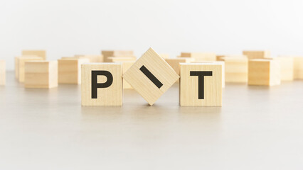 letters PIT on wooden blocks, white background
