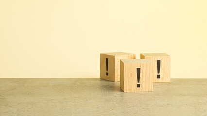 exclamation marks are written on wooden blocks. Blocks are located on a red background