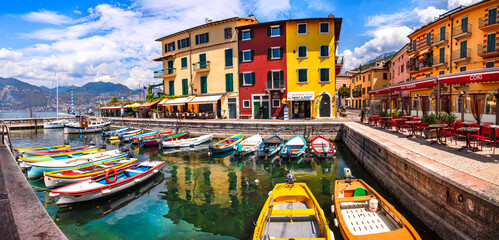 Scenic Lake Lago di Garda, Italy, Charming fishing village with colorful houses and boats - Castelletto di Brenzone. 28/07/2022 - obrazy, fototapety, plakaty