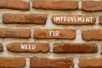 Need for improvement and support symbol. Concept words Need for improvement on red brick wall. Beautiful red brick wall background. Business and need for improvement quote concept. Copy space.