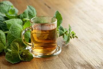 Mint tea on a wooden table.