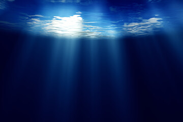 Deep dark blue underwater sea with sun rays and copy space background.