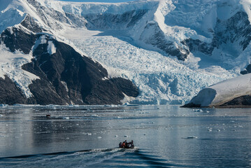 Tourists watching a glacier in Antarctica, near the Antarctic Peninsula.
