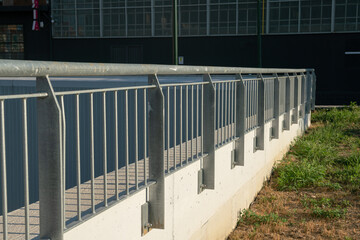 Public furniture: metal balustrade with a metal structure of linear geometry anchored to the wall,...