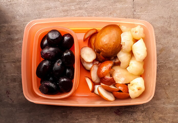 Lunch box / tiffin box contains tasty fruits for healthy diet, Top view.