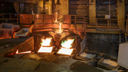 Process of pouring liquid hot copper into molds.