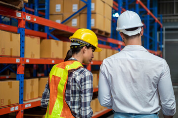 Young worker  working in an industrial place of work. logistics service, warehouse management and inventory concept.