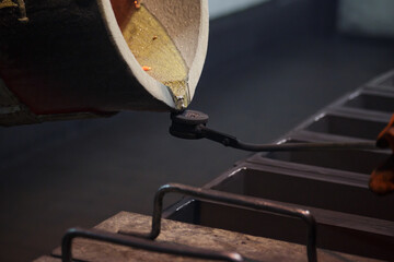 Pouring a sample of hot silver metal.