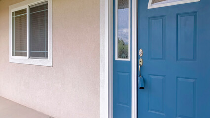 Fototapeta na wymiar Panorama Blue front door with lockbox, arched glass panes and sidelights