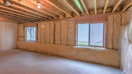 Panorama Unfinished basement with plastic vapor barrier and windows