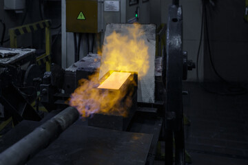 Pouring hot liquid gold into molds.