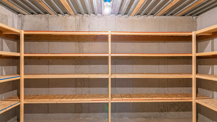 Panorama Unfinished food storage at the basement with concrete walls
