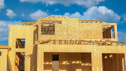 Panorama White puffy clouds Unfinished house structure with timber frame and cork wall insul