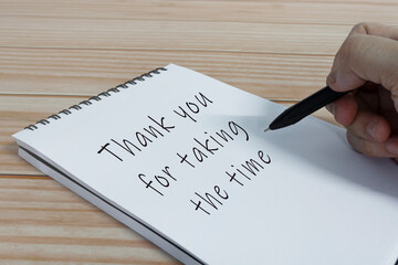 Hand writing thank you for taking the time text on notepad.