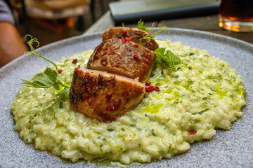 Creamy risotto with bear garlic and oil, filleted pork tenderloin sous vide with red pepper.