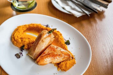 Roasted turkey meat with mashed pumpkin.