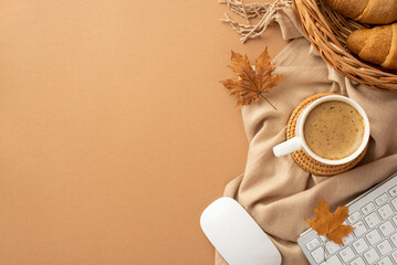 Autumn business concept. Top view photo of cup of coffee rattan placemat wicker tray with croissants computer mouse keyboard yellow maple leaves and scarf on isolated beige background with copyspace - obrazy, fototapety, plakaty
