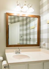 Vertical Small bathroom interior with checkered wallpaper on the right