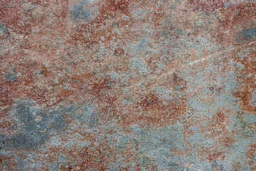 Old cracked painted textured brown background with blue spots.