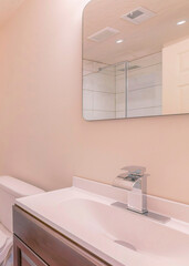Vertical Corner of a bathroom with toilet and wooden flooring