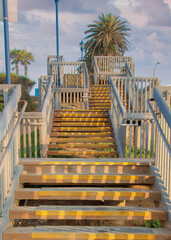Vertical Puffy clouds at sunset Outdoor stairs with anti-slip steps and lamp posts at Oceanside,