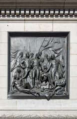 London, UK- July 4, 2022: Trafalgar Square. Closeup of black mural sculpture set in white marble pedestal of Nelson's Column depicts scene of naval battle at Copenhagen in 1801