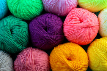 Colorful multicolored background from skeins of acrylic yarn. Textile industry. Arranged balls  of yarn. Natural and neon colors.
