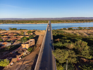 Beautiful bridge over the silver river in the morning sun on the edge of a small town in the...